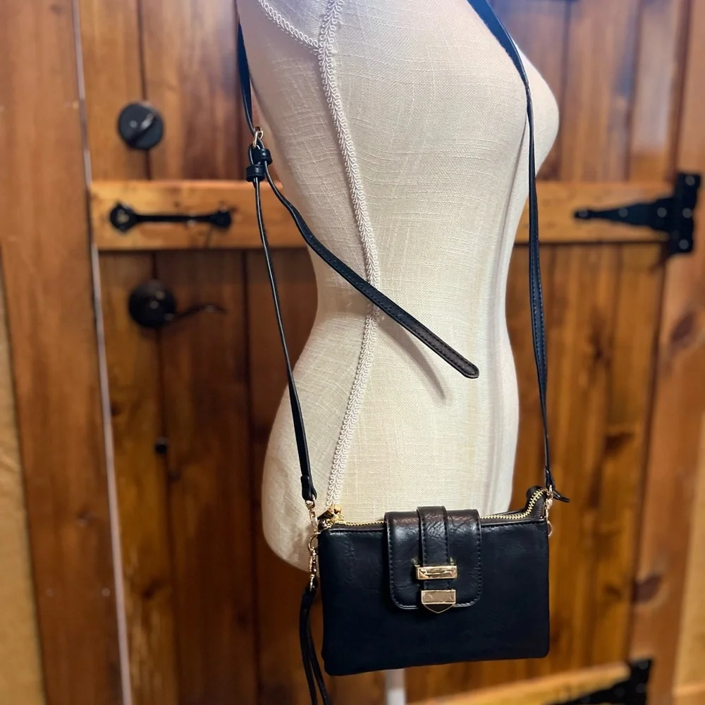 Madison West black wristlet 5 inches high by 7 inches wide with shoulder strap